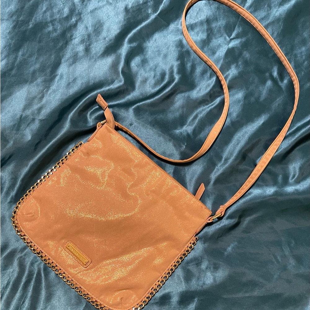 Metallic…shimmery…champagne Madden Girl crossbody with gold chain trim.